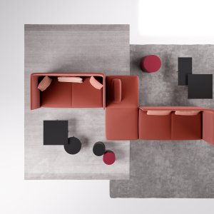 Hylde i eg med bærbar computer ved sofaer og loungemøbler Node+